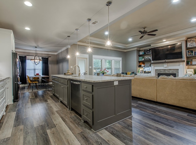 kitchen featuring white cabinetry, a kitchen island with sink, pendant lighting, and stainless steel dishwasher