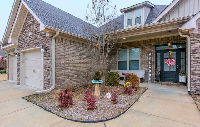 view of exterior entry with a garage and covered porch