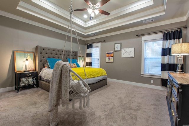 bedroom with a raised ceiling, ornamental molding, light colored carpet, and ceiling fan