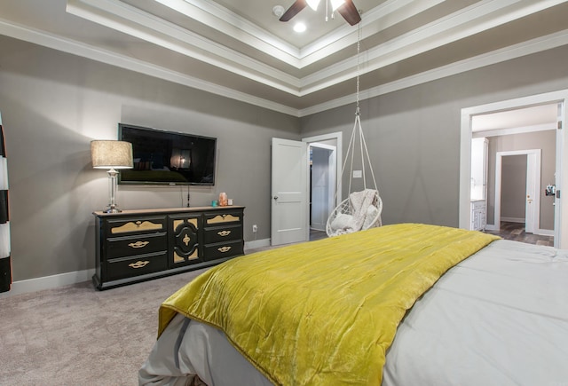 carpeted bedroom with crown molding, ceiling fan, and a tray ceiling