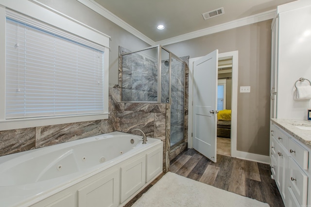 bathroom featuring vanity, wood-type flooring, ornamental molding, and plus walk in shower