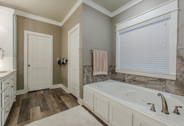 bathroom featuring crown molding, a tub to relax in, hardwood / wood-style floors, and vanity