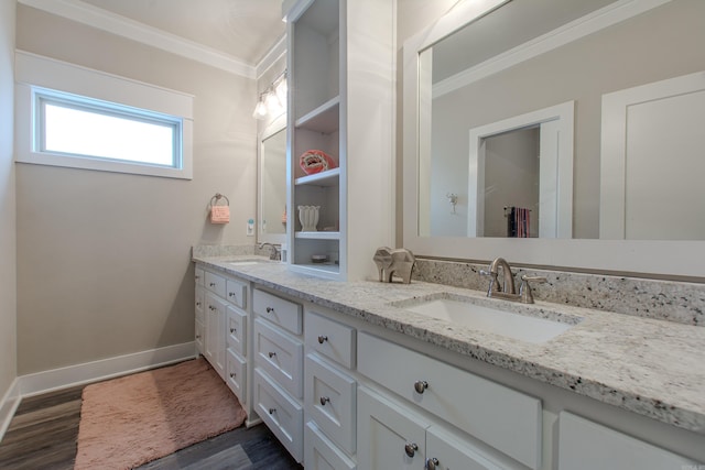 bathroom with hardwood / wood-style flooring, crown molding, and vanity