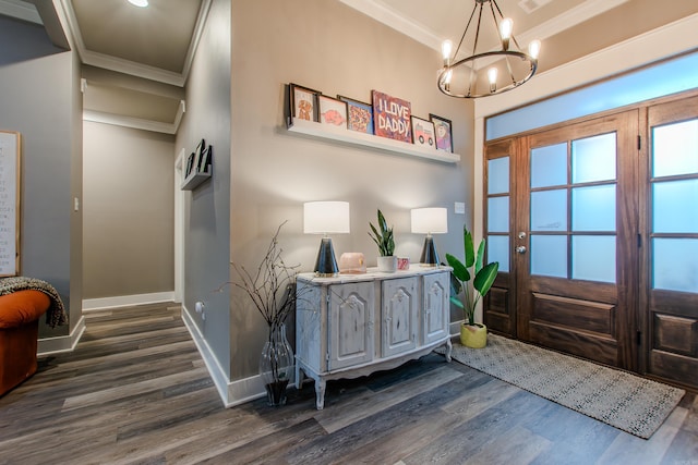 entryway with crown molding, dark hardwood / wood-style flooring, and a chandelier