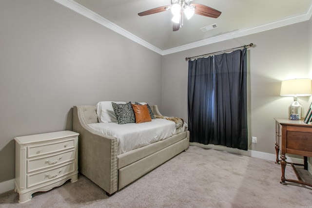 carpeted bedroom featuring ornamental molding and ceiling fan