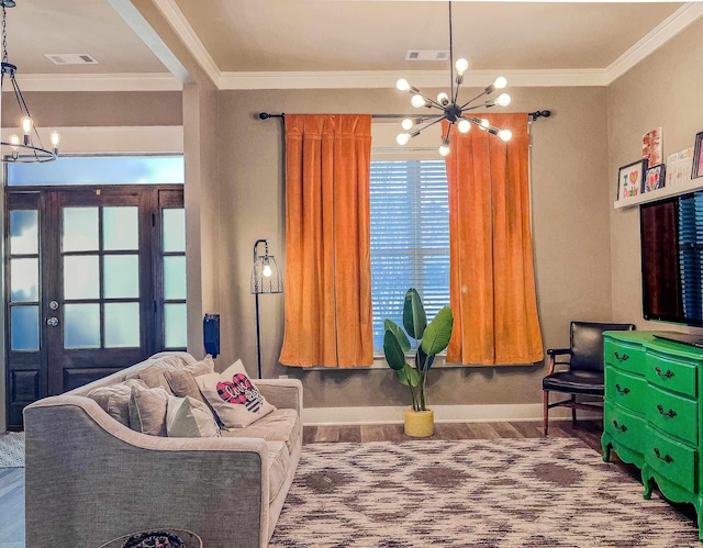 living room with an inviting chandelier and ornamental molding