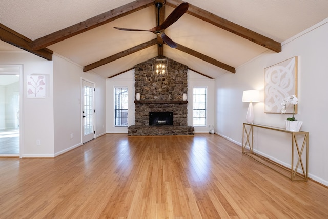 unfurnished living room featuring vaulted ceiling with beams, a stone fireplace, and light wood-type flooring