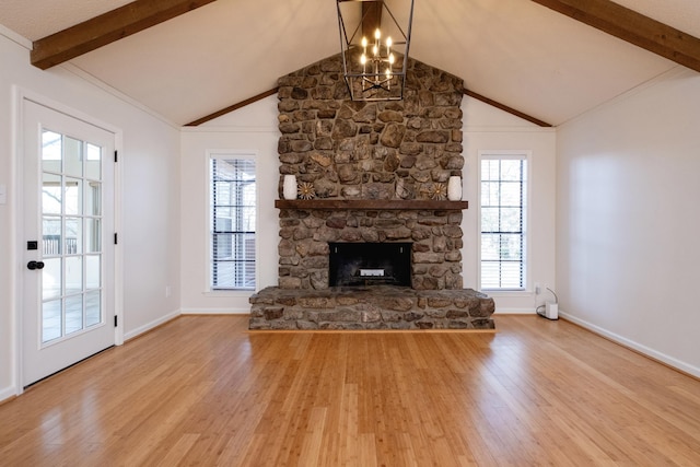 unfurnished living room with hardwood / wood-style floors, a notable chandelier, a fireplace, and vaulted ceiling with beams