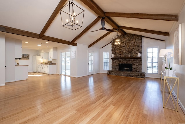 unfurnished living room featuring light hardwood / wood-style flooring, a fireplace, high vaulted ceiling, and beamed ceiling