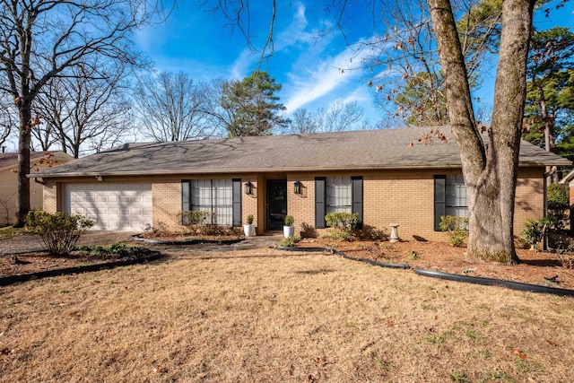 ranch-style home with a garage and a front yard