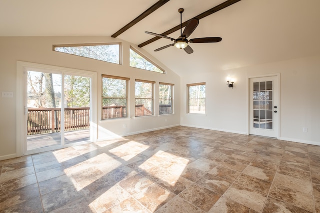 unfurnished sunroom featuring ceiling fan and vaulted ceiling with beams