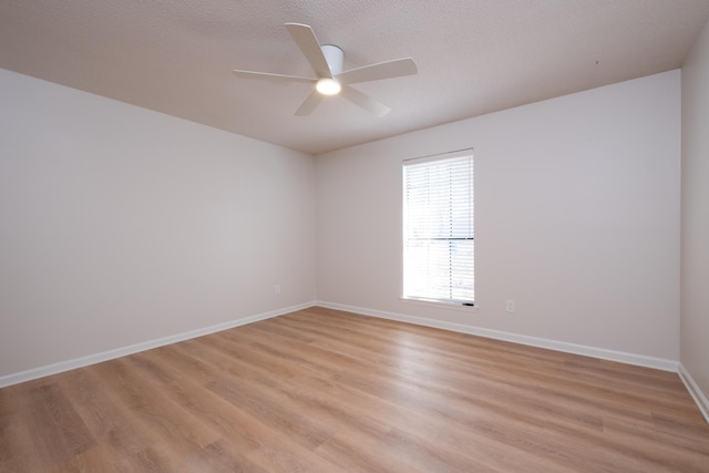 spare room with a textured ceiling, light hardwood / wood-style flooring, and ceiling fan