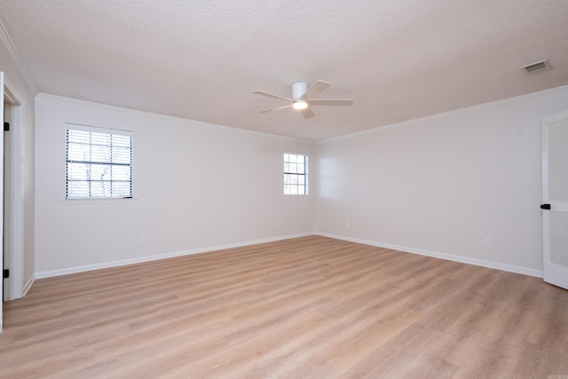 unfurnished room with ornamental molding, a textured ceiling, and light wood-type flooring