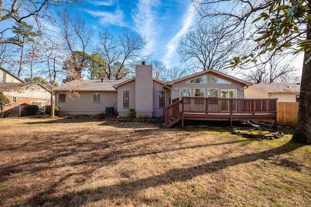 back of house featuring a wooden deck, central AC unit, and a lawn