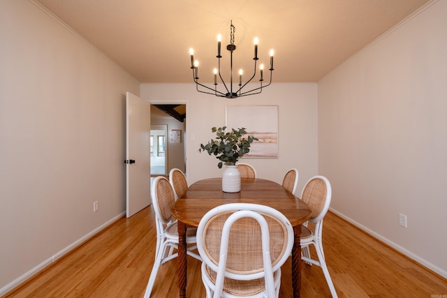 dining area featuring crown molding and light wood-type flooring