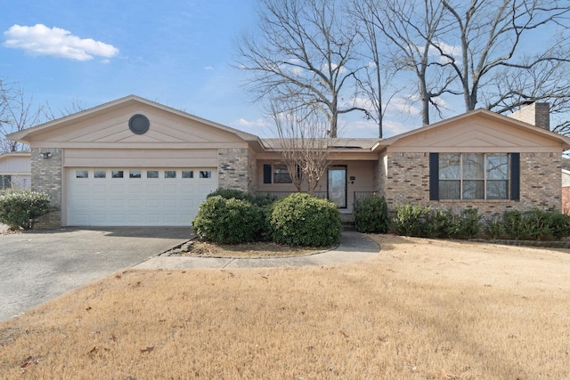 single story home featuring a garage and a front yard