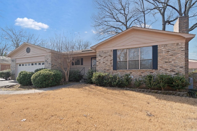 view of front of property featuring a garage and a front lawn