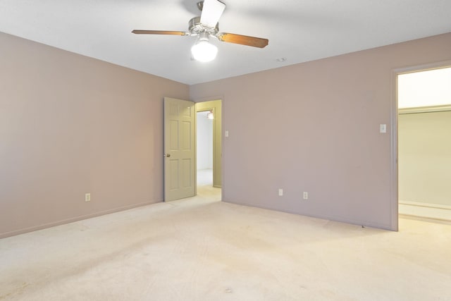 unfurnished room with light colored carpet and ceiling fan