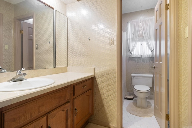 bathroom featuring tile patterned flooring, vanity, and toilet