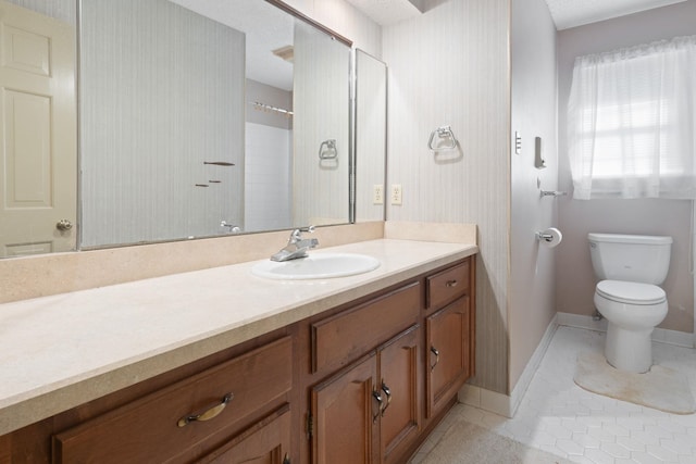 bathroom featuring vanity, tile patterned floors, toilet, and walk in shower