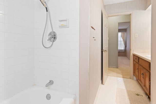 bathroom featuring tiled shower / bath and vanity