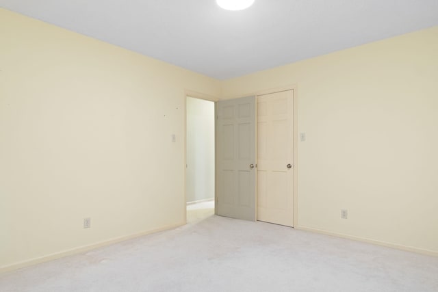 unfurnished bedroom with light carpet