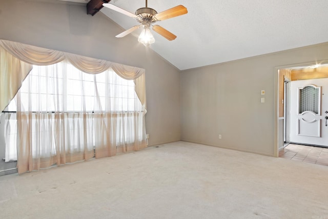 unfurnished room with ceiling fan, light colored carpet, and lofted ceiling with beams