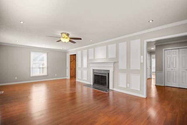 unfurnished living room featuring ceiling fan, ornamental molding, and wood-type flooring