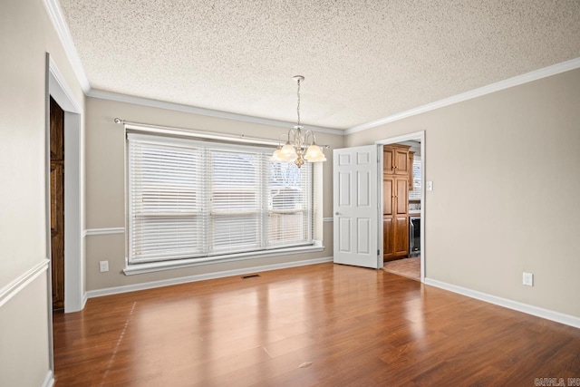 unfurnished dining area featuring crown molding, hardwood / wood-style floors, and a notable chandelier