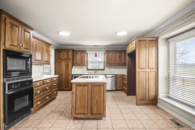 kitchen with sink, a wealth of natural light, black appliances, and a center island