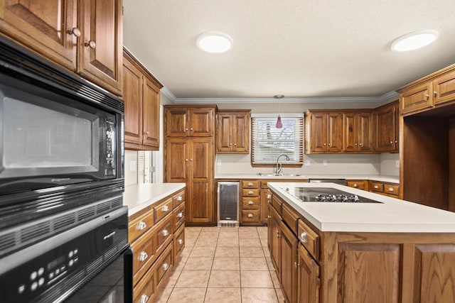 kitchen featuring sink, light tile patterned floors, a center island, wine cooler, and black appliances