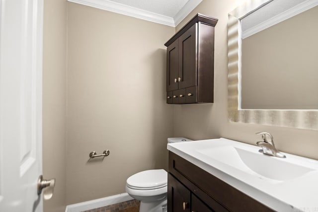 bathroom with crown molding, vanity, and toilet