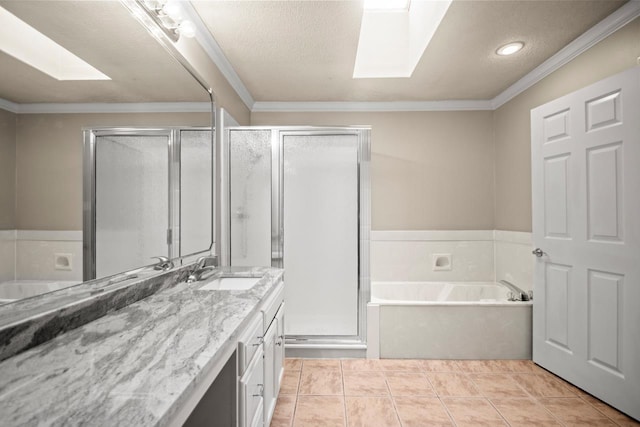 bathroom featuring ornamental molding, a skylight, and vanity