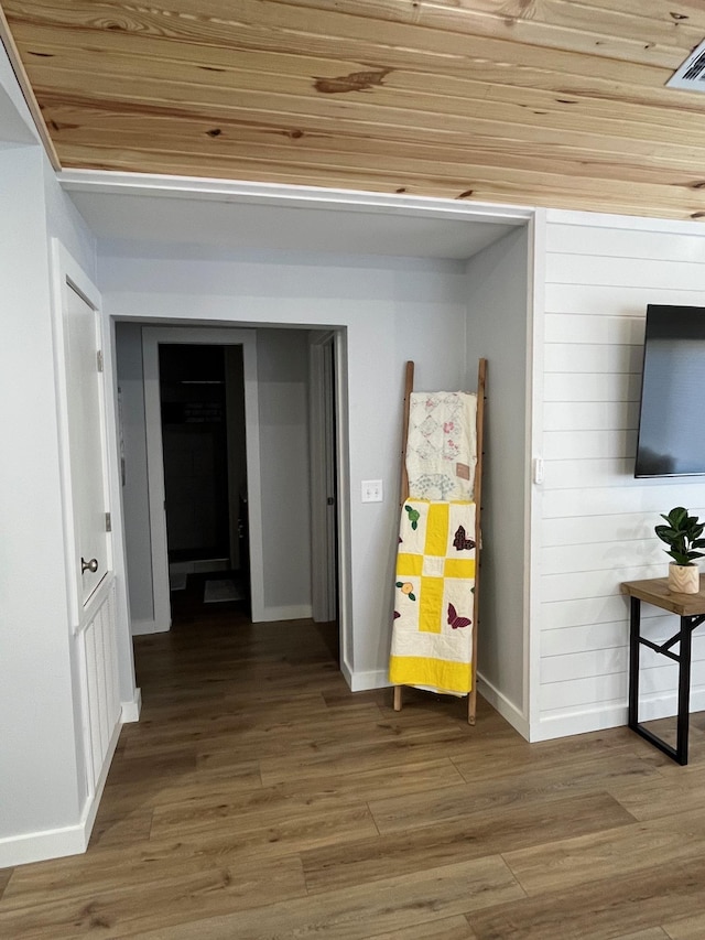 corridor featuring wood-type flooring and wood ceiling