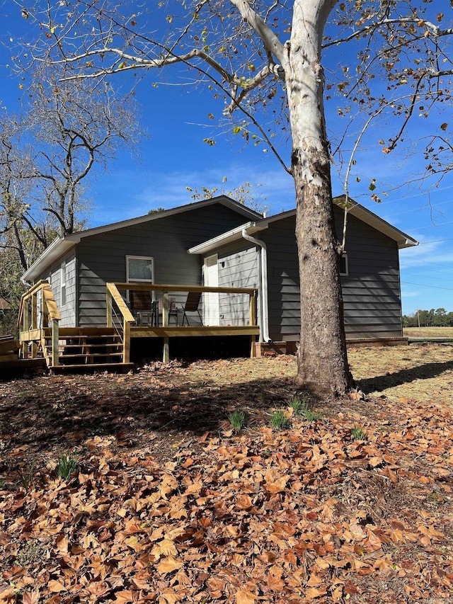 rear view of house with a wooden deck