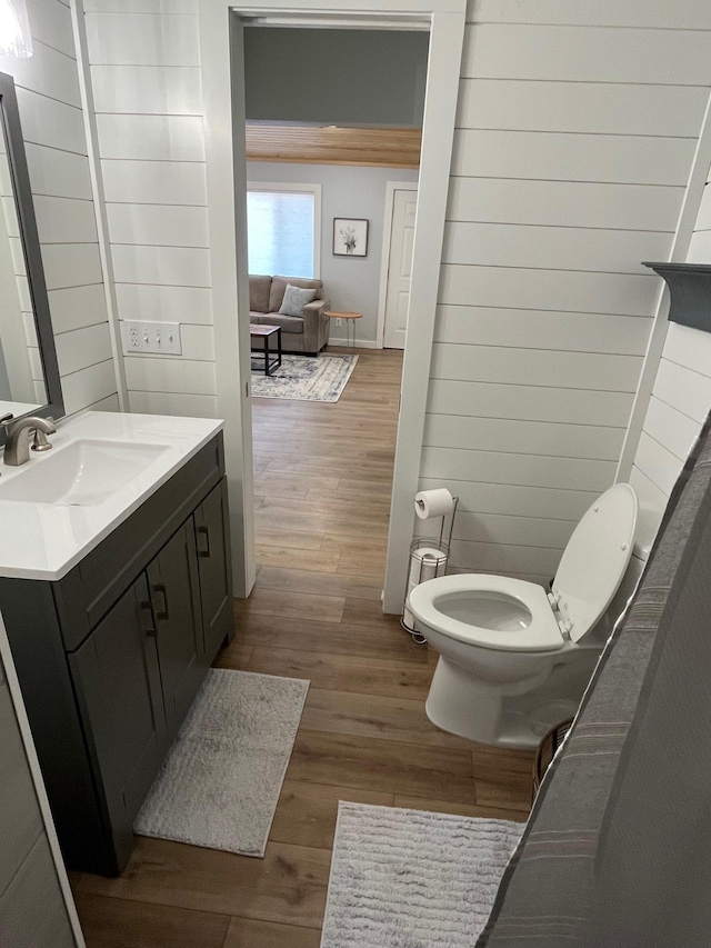 bathroom featuring vanity, wood-type flooring, and toilet