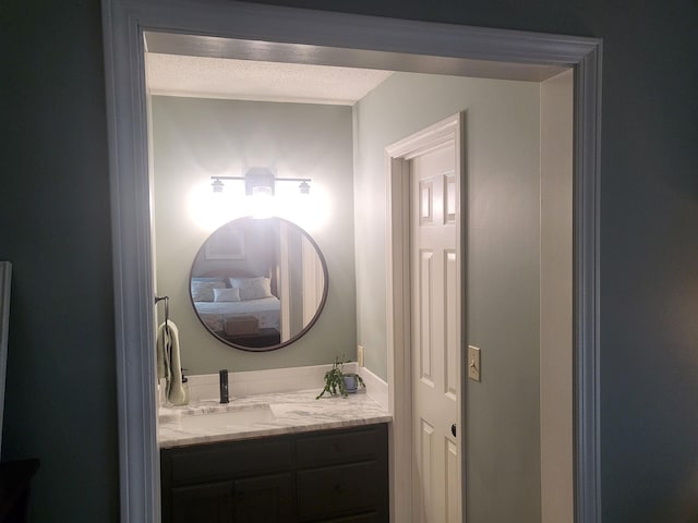 bathroom with vanity and a textured ceiling