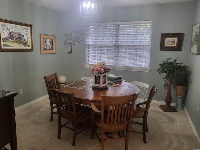 dining space with light colored carpet