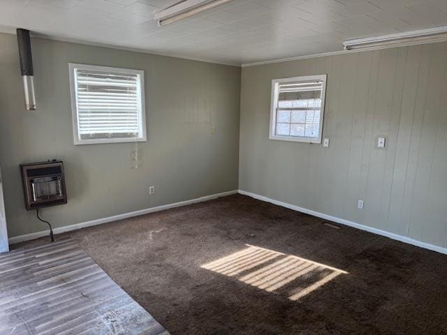 spare room with dark wood-type flooring and heating unit