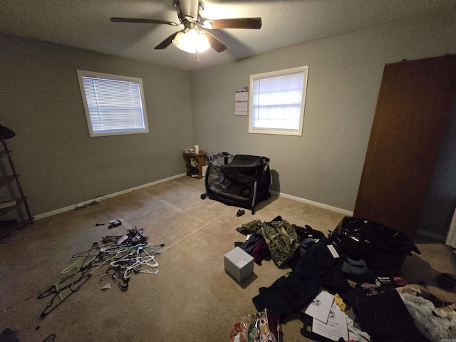 misc room with ceiling fan and light carpet