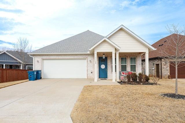 view of front of home with a garage, a porch, and a front lawn