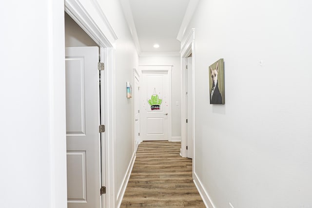 hallway featuring ornamental molding and dark wood-type flooring