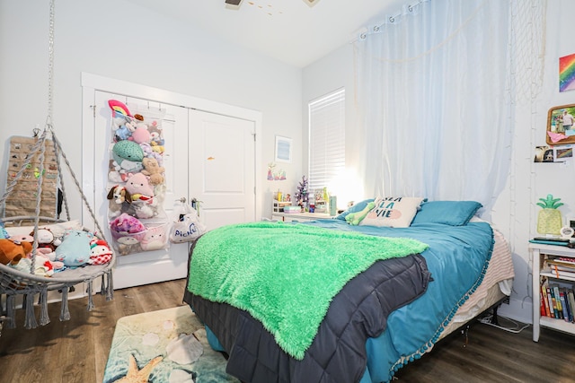 bedroom featuring dark hardwood / wood-style flooring and a closet