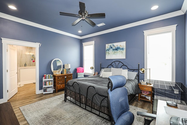 bedroom featuring wood-type flooring, ornamental molding, and ceiling fan