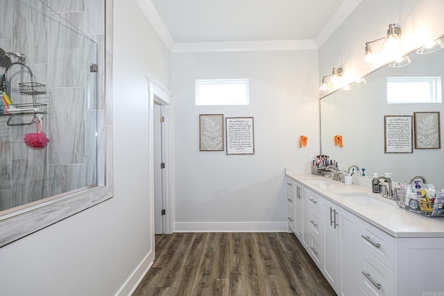 bathroom featuring crown molding, vanity, and hardwood / wood-style floors