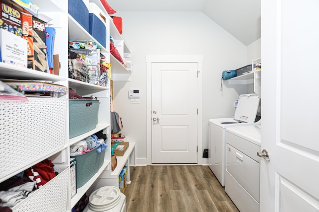 laundry room with wood-type flooring and independent washer and dryer