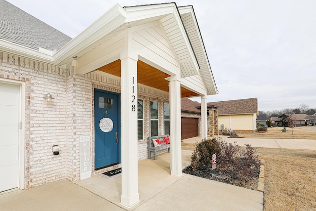 entrance to property with a garage and a porch