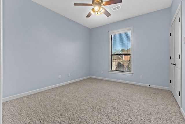 carpeted spare room featuring ceiling fan