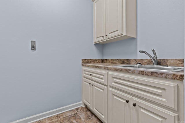 laundry area featuring cabinets and sink