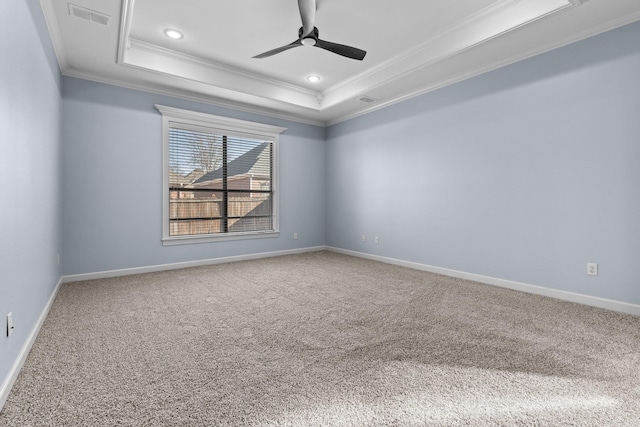 unfurnished room featuring a raised ceiling, crown molding, carpet flooring, and ceiling fan